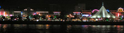 Neon encrusted shoreline at night.