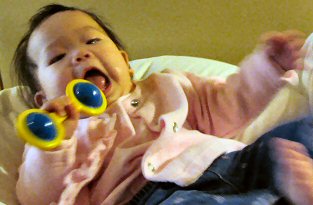 Caden playing with a rattle.