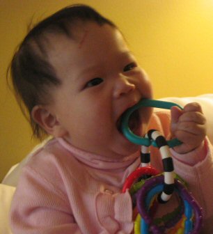 Caden playing with a teething ring.