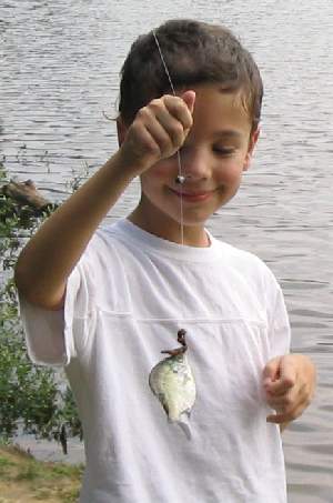 Austin with a small sunfish at the end of the line.
