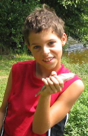 Christopher with a small bass in his hand.