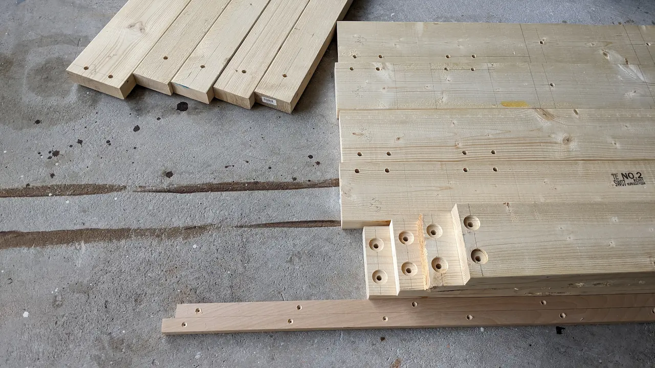 Cut lumber with holes and counter sinks.